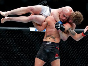 Robbie Lawler picks up Ben Askren in a welterweight mixed martial arts bout at UFC 235, Saturday, March 2, 2019, in Las Vegas.