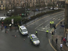 Police secure the area outside the University of Glasgow, Scotland, after a suspicious package was found at the university, Wednesday, March 6, 2019.