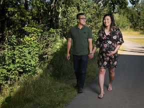 Christina Ryan, Calgary Herald Calgary, Alberta: AUGUST 03, 2017 - Paul Lee and Sarah Yoo, who are expecting in August, stand outside their new home in the community of The Rise at West Grove Estates, in Calgary on July 29, 2017. (Christina Ryan/Calgary Herald) (For New Homes section story by ) Trax# 000