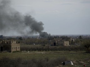 Smoke rises from a strike on Baghouz, Syria, on the Islamic State group's last piece of territory on Friday, March 22, 2019.