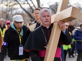 Bishop William McGrattan leaves St. Mary's Cathedral during the outdoor Way of the Cross procession in Calgary on Friday, April 19, 2019. Around one thousand people participated in this annual event.