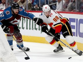 DENVER, COLORADO - APRIL 17:  Patrik Nemeth #12 of the Colorado Avalanche fights for the puck against Andrew Mangiapane #88 of the Calgary Flames in the first period during Game Four of the Western Conference First Round during the 2019 NHL Stanley Cup Playoffs at the Pepsi Center on April 17, 2019 in Denver, Colorado. (Photo by Matthew Stockman/Getty Images)