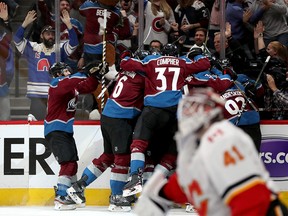 DENVER, COLORADO - APRIL 17:  Members of the Colorado Avalanche celebrate their overtime win over the Calgary Flames during Game Four of the Western Conference First Round during the 2019 NHL Stanley Cup Playoffs at the Pepsi Center on April 17, 2019 in Denver, Colorado. (Photo by Matthew Stockman/Getty Images)