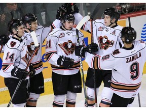 The Calgary Hitmen congratulate Riley Fiddler-Schultz, centre, after he scored on the Edmonton Oil Kings during WHL action at the Scotiabank Saddledome in Calgary on Sunday March 17, 2019.  Gavin Young/Postmedia