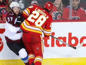 Calgary Flames Elias Lindholm collides with J. T. Compher of the Colorado Avalanche in Game 1 at the Saddledome on April 11, 2019.