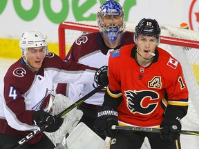 Calgary Flames Matthew Tkachuk battles against Tyson Barrie of the Colorado Avalanche during NHL hockey at the Scotiabank Saddledome in Calgary on Wednesday, January 9, 2019. Al Charest/Postmedia