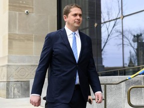 Conservative leader Andrew Scheer walks to a press conference at the National Press Theatre in Ottawa on Sunday, April 7, 2019.