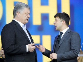 Ukrainian President Petro Poroshenko, left, and Ukrainian presidential candidate and popular comedian Volodymyr Zelenskiy, right, argue their debates at the Olympic stadium in Kiev, Ukraine, Friday, April 19, 2019.