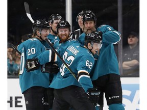 San Jose Sharks' Marcus Sorensen (20), Joakim Ryan (47), Joe Thornton (19), celebrate with Kevin Labanc (62), center, who scored goal against the Colorado Avalanche in the second period of Game 1 of an NHL hockey second-round playoff series at the SAP Center in San Jose, Calif., on Friday, April 26, 2019.