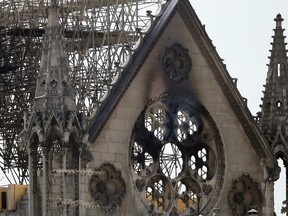 A worker checks on a wooden support structure placed on the Notre Dame Cathedral in Paris, Wednesday, April 17, 2019. (AP Photo/Francois Mori)