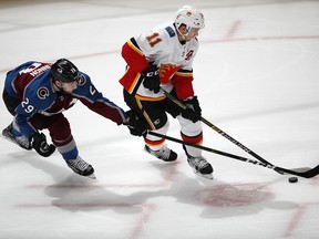 Colorado Avalanche forward Nathan MacKinnon checks Flames centre Mikael Backlund in the first period of Game 4.