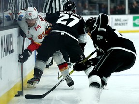 Calgary Flames forward Sam Bennett fights for the puck along the boards during a game against the Los Angeles Kings on April 1, 2019.