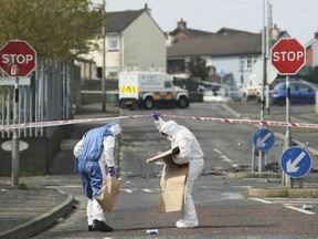 Police forensic officers at the scene in Derry, Northern Ireland, Friday April 19, 2019, following the death of 29-year-old journalist Lyra McKee who was shot and killed during rioting.