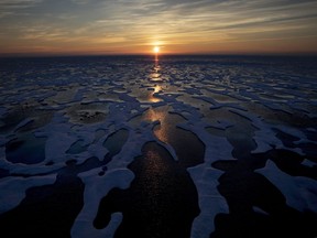 The midnight sun shines across sea ice along the Northwest Passage in the Canadian Arctic Archipelago, on July 22, 2017. Canada is warming up twice as fast as the rest of the world and that warming is "effectively irreversible" a scientific report from Environment and Climate Change Canada says.