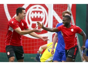 Cavalry FC Dominick Zator (L) and Tofa Fukunle celebrate a goal during a friendly match during a training session at Foothills Fieldhouse in Calgary. Jim Wells/Postmedia
