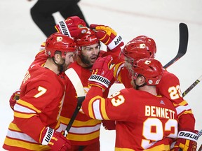 Flames teammates celebrate a first period goal by TJ Brodie (7) during game five between the Colorado Avalanche and Calgary Flames in Calgary on Friday, April 19, 2019. Jim Wells/Postmedia