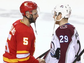 Flames Mark Giordano (L) shakes hands with Avalanche Nathan MacKinnon following game five between the Colorado Avalanche and Calgary Flames in Calgary on Friday, April 19, 2019. Jim Wells/Postmedia