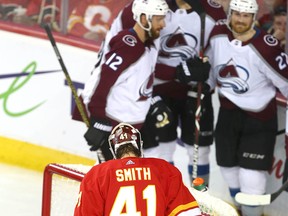 Flames goalie Mike Smith looks on as Avalanche celebrate a third goal during game five between the Colorado Avalanche and Calgary Flames in Calgary on Friday, April 19, 2019. Jim Wells/Postmedia