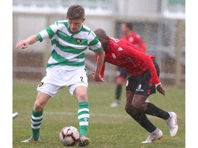 Foothills FC Daniel Pritchard (L) shields the ball in front of Cavalry FC Jordan Brown during a friendly match between Cavalry and Foothills FC in Calgary at Spruce Meadows Saturday, April 27, 2019.  Jim Wells/Postmedia