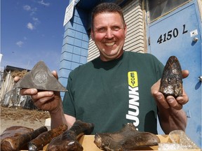 Mike Darbyshire, Owner of Just Junk, found thousands of fossilized bones and imprints and pieces petrified wood. The discovery was made in several boxes and bags in the basement and shed of home while cleaning-up. He plans to donate them to the Royal Tyrrell Museum on Friday. Thursday, April 4, 2019. Brendan Miller/Postmedia