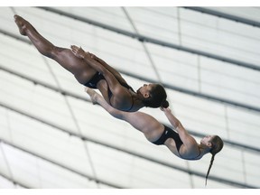 Canada's Jennifer Abel, left, and Melissa Citrini-Beaulieu compete during the women's 3-metre open synchro finals event at the FINA Diving Grand Prix in Calgary, Alta., Sunday, April 7, 2019.THE CANADIAN PRESS/Jeff McIntosh ORG XMIT: JMC111