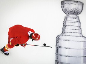 Calgary Flames forward Michael Frolik skates over an image of the Stanley Cup at Scotiabank Saddledome during a practice on Tuesday, April 9, 2019.