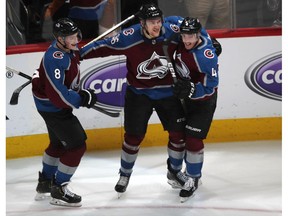 Colorado Avalanche right wing Mikko Rantanen, center, celebrates his overtime goal with defensemen Cale Makar, left, and Tyson Barrie in Game 4 of an NHL hockey playoff series against the Calgary Flames on Wednesday, April 17, 2019, in Denver. The Avalanche won 3-2.