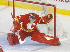 Calgary Flames goalie Mike Smith makes a glove save on a Colorado Avalanche shot in second period action of game 1 of the NHL Play-Offs at the Scotiabank Saddledome in Calgary on  Thursday, April 11, 2019. Darren Makowichuk/Postmedia