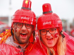 Calgary Flames fans, Ryan and Hailey McKenzie brave the weather to take in the Redline Party as the Flames start their Play Off run at the Scotiabank Saddledome in Calgary on Thursday, April 11, 2019. Darren Makowichuk/Postmedia