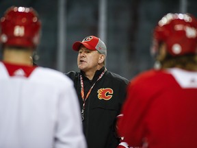 Calgary Flames' head coach Bill Peters talks to players during practice in Calgary on Tuesday, April 9, 2019.