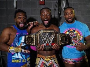Kofi Kingston (centre) celebrates with The New Day (Xavier Woods and Big E) after winning the WWE World Heavyweight Championship. (WWE Photo)