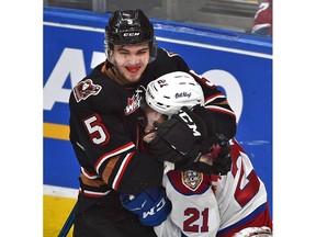 Edmonton Oil Kings Jake Neighbours (21) gets grabbed around the neck by Calgary Hitmen Jackson van de Leest (5) during WHL second round playoff action at Rogers Place in Edmonton, April 6, 2019. Ed Kaiser/Postmedia