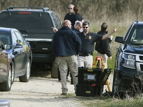 Investigators from the Crystal Lake police department, the McHenry County Sheriff's Office and the FBI gather at an area northwest of Dean Street and Route 176 in unincorporated Woodstock, Ill., on Wednesday, April 24, 2019.