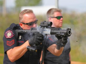 Calgary police Sgt. Dan Fraser fires the ARWEN ACE-T launcher during a media demonstration on Thursday, June 28, 2018. The weapon, which fires plastic rounds, is part of a "Less Lethal" initiative by CPS.