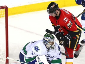 Calgary Flames Sam Bennett was all over Vancouver Canucks goalie Eddie Lack in third period NHL Play-Off action at the Scotiabank Saddledome in Calgary, Alta. on Sunday April 19, 2015. Darren Makowichuk/Calgary Sun/Postmedia Network