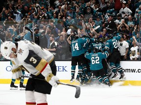 Barclay Goodrow of the San Jose Sharks is mobbed by teammates after scoring in overtime in Game 7, eliminating the Vegas Golden Knights in San Jose on April 23, 2019.
