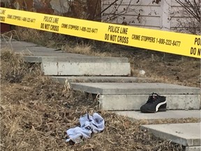 A man's shoe and shirt are seen on the front steps of a home in Temple spattered with blood where a man was shot multiple times on Tuesday April 9, 2019. (Ryan Rumbolt / Postmedia)