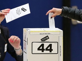 Voters in Calgary-Mountain View cast ballots at Langevin School soon after the polls opened on Tuesday morning, April 16, 2019.