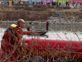 Calgary Fire Rescue are seen looking for a person in the Bow River near the Langevin Bridge on Saturday, April 20, 2019. Brendan Miller/Postmedia