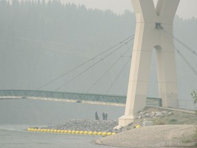 Police investigate the scene of a possible murder-suicide on the Stoney Trail bridge over Bow River on Friday, May 31, 2019.
