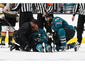 SAN JOSE, CALIFORNIA - APRIL 23:  Joe Pavelski #8 of the San Jose Sharks is looked on after a hard hit by the Vegas Golden Knights in the third period in Game Seven of the Western Conference First Round during the 2019 NHL Stanley Cup Playoffs at SAP Center on April 23, 2019 in San Jose, California.