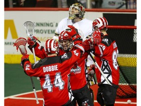 Calgary Roughnecks Chris Boushy, middle, celebrates his goal on the Vancouver Warriors  during their game at the Scotiabank Saddledome in Calgary, on Saturday December 15, 2018. Leah Hennel/Postmedia ORG XMIT: POS1812152216552633