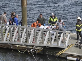 Emergency response crews transport an injured passenger to an ambulance at the George Inlet Lodge docks, Monday, May 13, 2019, in Ketchikan, Alaska. (Dustin Safranek/Ketchikan Daily News via AP)