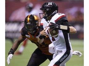 BC Lions defensive end Ivan McLennan (98) sacks Ottawa Redblacks quarterback Trevor Harris (7) during the first half of CFL football action in Vancouver, B.C., on Friday, Sept. 7, 2018.