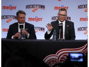 Steve Yzerman, center, addresses the media during an NHL hockey news conference where he was introduced as the new executive vice president and general manager of the Detroit Red Wings, Friday, April 19, 2019, in Detroit.. At left is senior vice president Ken Holland.