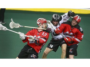 Roughnecks sniper Curtis Dickson (left) goes to the net as teammate Tyler Pace (right) blocks out Colorado Mammoth defender Robert Hope (centre) during National Lacrosse League West Division final action between the Calgary Roughnecks and Colorado Mammoth in Calgary on Friday, May 10, 2019. Jim Wells/Postmedia