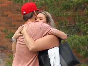 Crystal Arnold hugs her grade 11 son in front of Lord Beaverbrook High School in Calgary on Thursday, May 30, 2019. She raced to the school to find her two grade 11 kids after a shooting scare at the school.