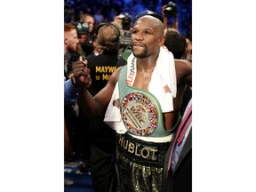 LAS VEGAS, NV - AUGUST 26:  Floyd Mayweather Jr. celebrates with the WBC Money Belt after his TKO of Conor McGregor in their super welterweight boxing match on August 26, 2017 at T-Mobile Arena in Las Vegas, Nevada.