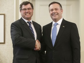 Alberta premier Jason Kenney shakes hands with Rick Wilson, Minister of Indigenous Relations after being sworn into office, in Edmonton on Tuesday April 30, 2019.