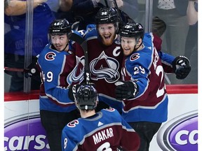 Colorado Avalanche left wing Gabriel Landeskog is congratulated by teammates Samuel Girard, Nathan MacKinnon and Cale Makar after scoring the overtime goal against the San Jose Sharks in Game 6 of an NHL hockey second-round playoff series, Monday night in Denver. Colorado won 4-3 in overtime.